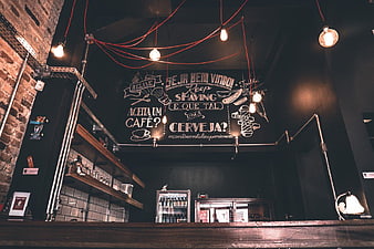 Industrial Barbershop Interior with Chalkboard Menu and Edison Bulbs