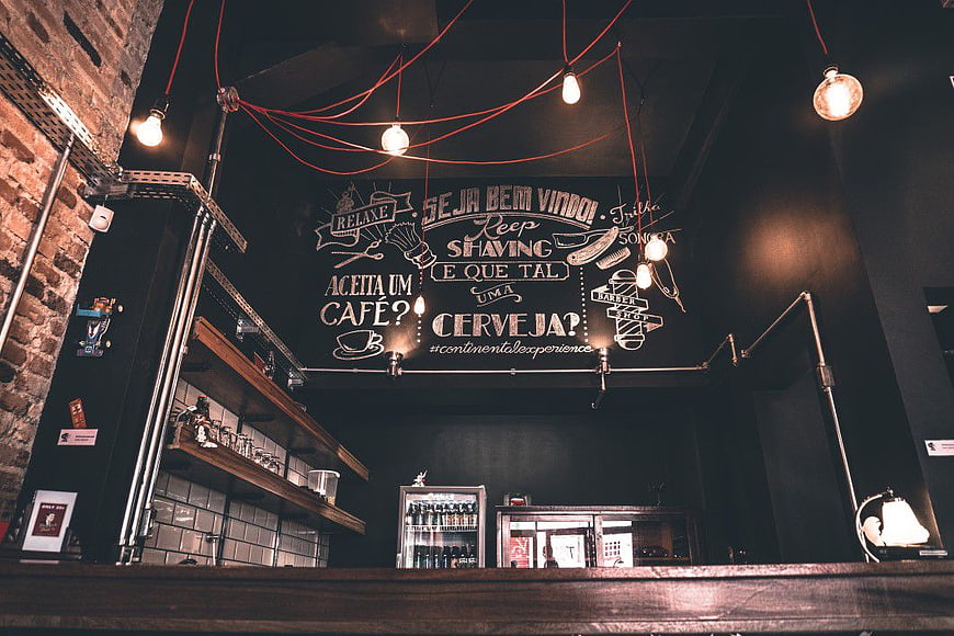 Industrial Barbershop Interior with Chalkboard Menu and Edison Bulbs