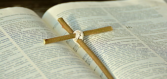 Wooden Cross on Open Bible Pages