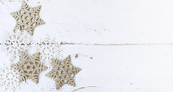 Gold and White Glitter Snowflakes on White Wood Background