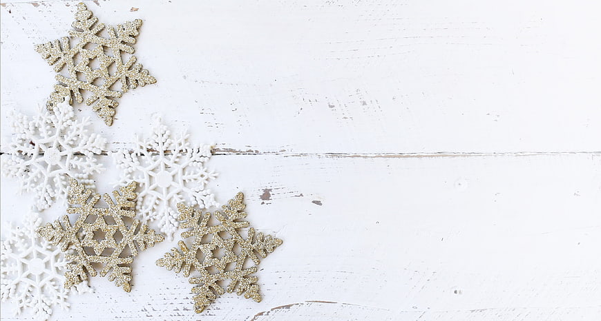 Gold and White Glitter Snowflakes on White Wood Background