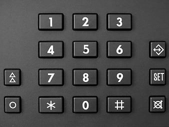 Close-up of black security keypad with white numbers