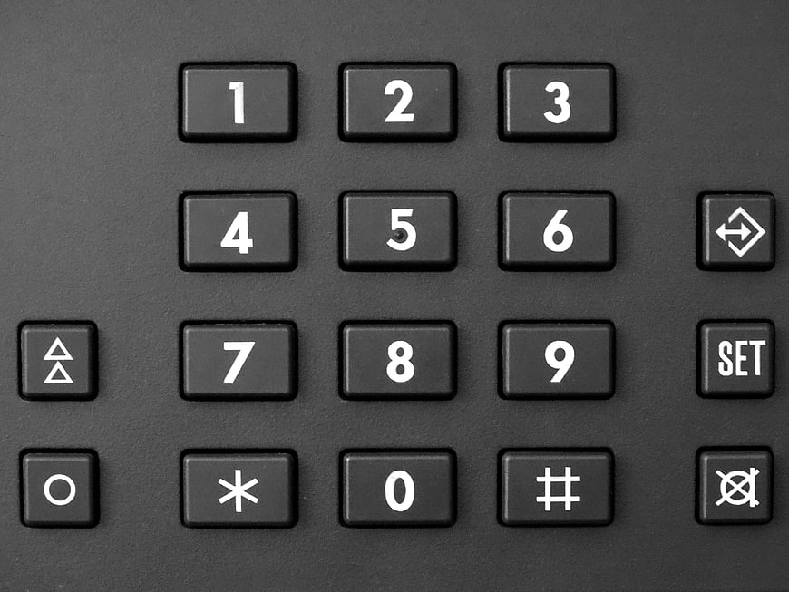 Close-up of black security keypad with white numbers