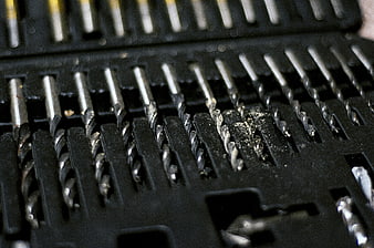 Close-up of metal drill bits in black case