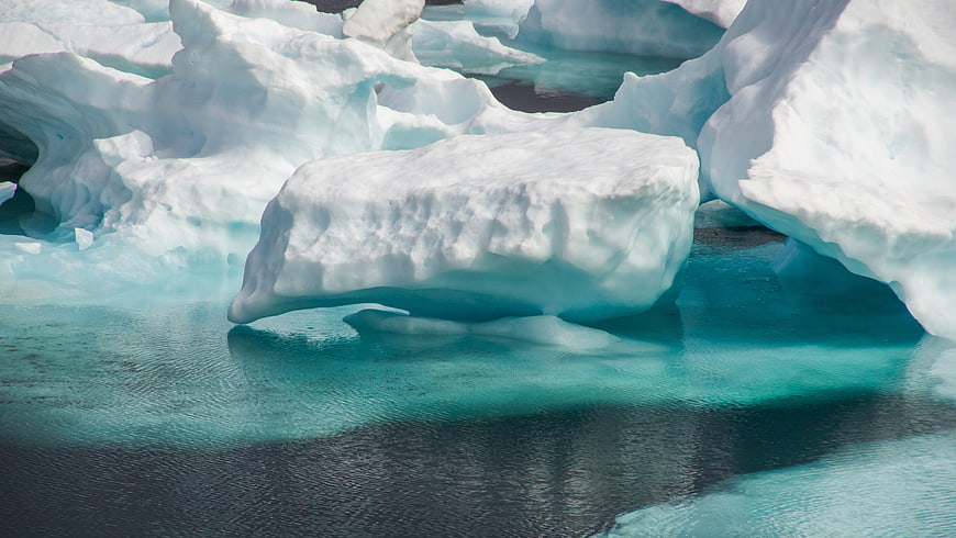Floating Iceberg in Turquoise Arctic Waters