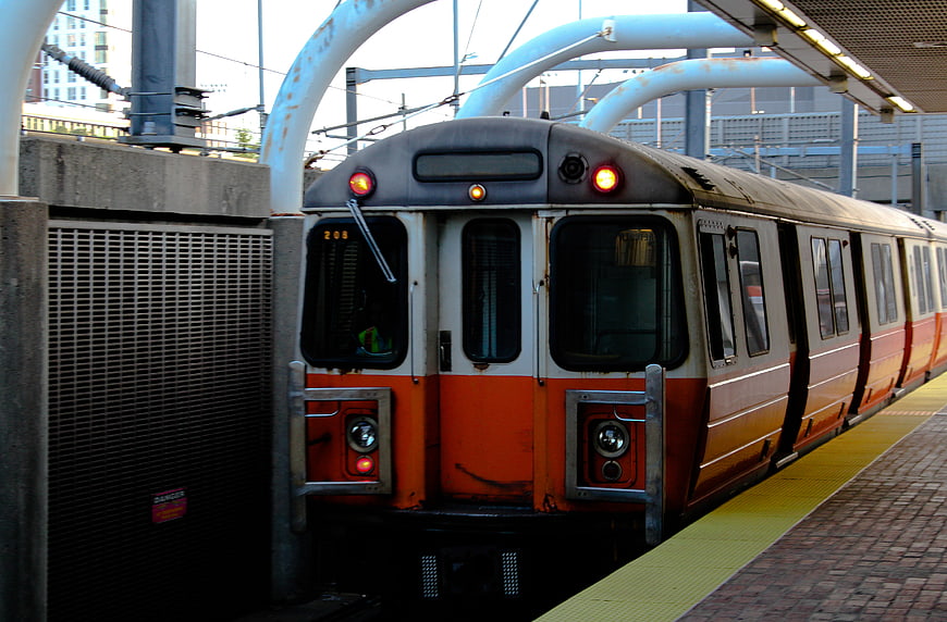 Orange and White Commuter Train at Urban Station Platform