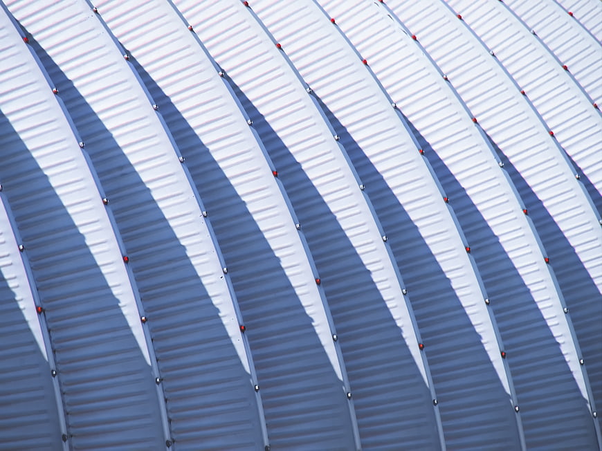Abstract Curved Metal Roof with Rhythmic Shadows
