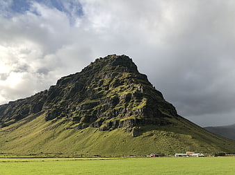 Dramatic Green Mountain Landscape in Iceland with Cloudy Sky