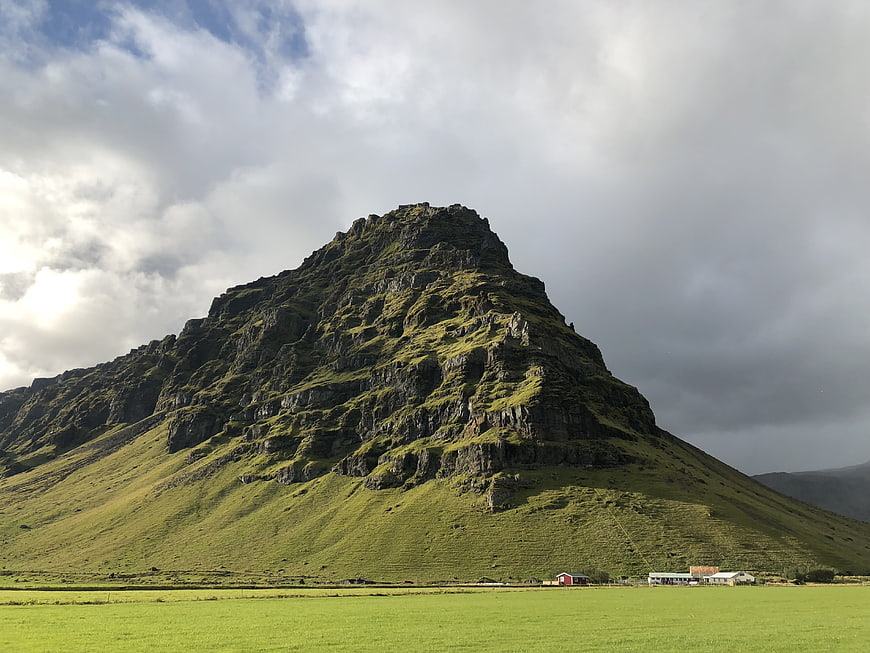 Dramatic Green Mountain Landscape in Iceland with Cloudy Sky