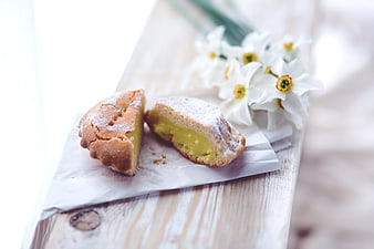 Lemon Muffin with White Daffodils on Wooden Board