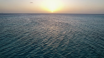 Serene Ocean Sunset with Golden Horizon and Gentle Waves