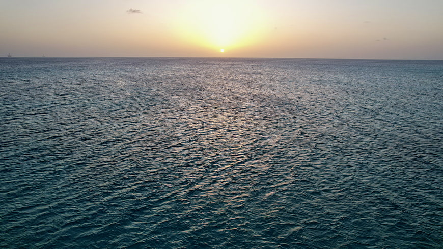 Serene Ocean Sunset with Golden Horizon and Gentle Waves