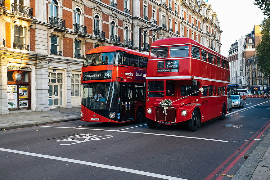 Vintage and Modern Red Double Decker Buses on London Street