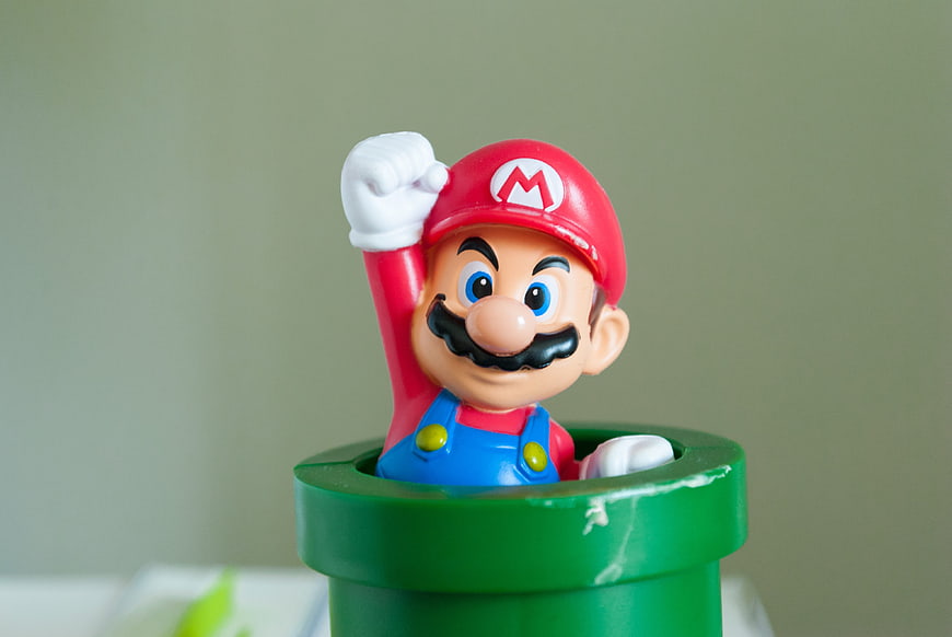 Super Mario Figure Emerging from Green Warp Pipe