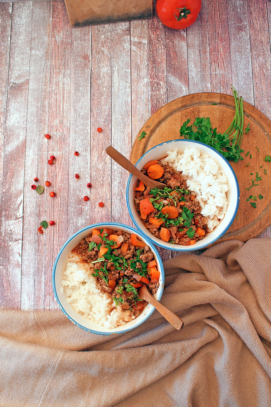 Top View of Ground Beef and Rice Bowls on Rustic Wood