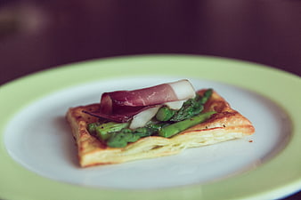 Gourmet asparagus and prosciutto tart on a plate