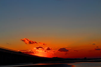 Dramatic Sunset Over Bridge Silhouette