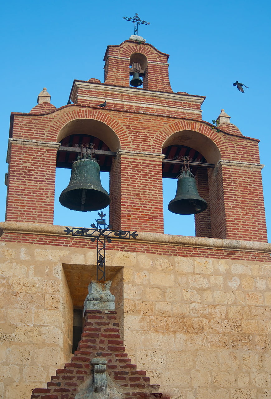 Red Brick Church Bell Tower Against Blue Sky