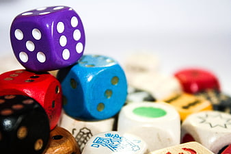 Close-up of colorful wooden dice stacked on white background