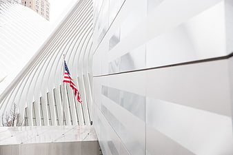 Modern white architecture with American flag and ribbed structure