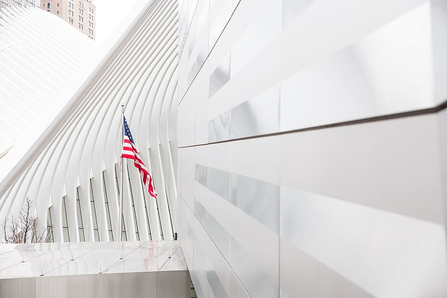Modern white architecture with American flag and ribbed structure