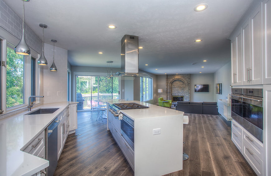 Modern open concept kitchen with white cabinets and island