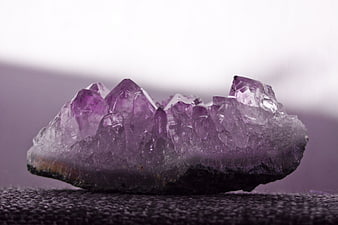 Raw Amethyst Crystal Cluster On Textured Surface