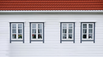 White House Facade with Red Roof and Blue Windows