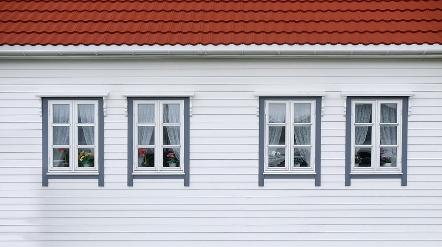 White House Facade with Red Roof and Blue Windows