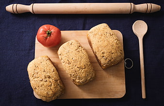 Flat lay of homemade whole grain bread loaves on wooden board