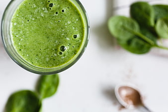 Top View of Green Spinach Smoothie with Fresh Leaves