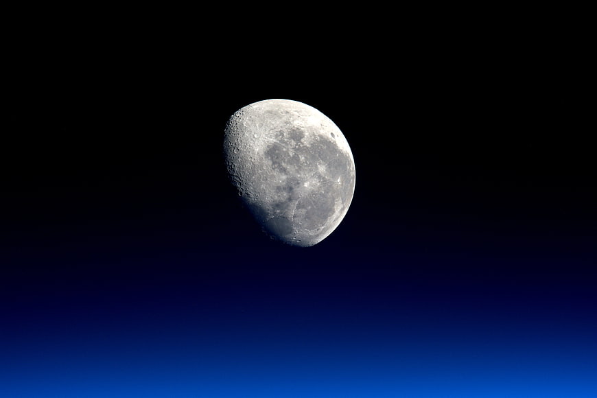 Gibbous Moon Against Deep Blue Night Sky Gradient