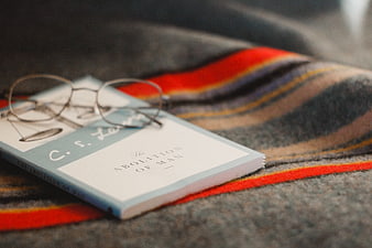 C.S. Lewis The Abolition of Man Book with Glasses on Plaid Blanket