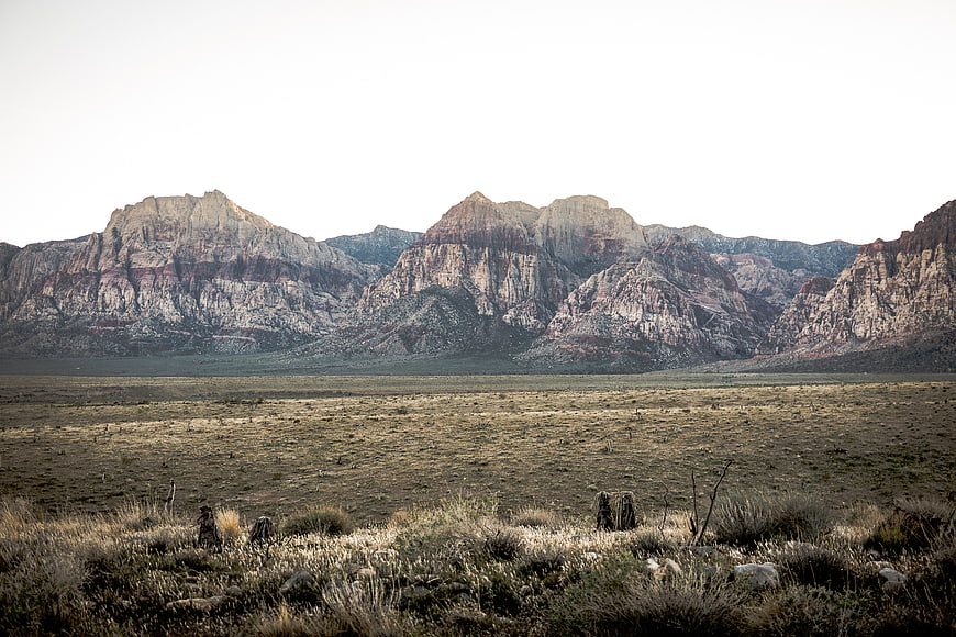 Vast desert landscape with rugged mountains and dry grass