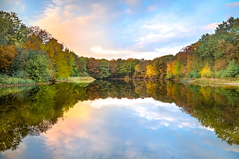 Serene autumn river landscape with colorful forest reflections