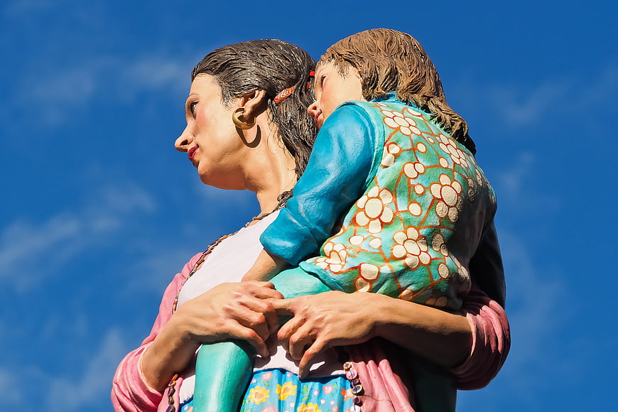 Colorful Sculpture of Mother and Child Against Blue Sky