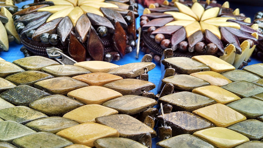 Handcrafted Stone and Wood Adornments on Blue Background