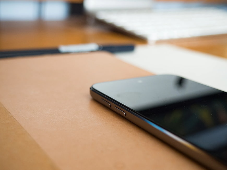 Close-up of Smartphone on Leather Notebook