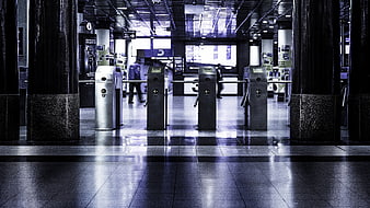 Empty subway station turnstiles with blue lighting