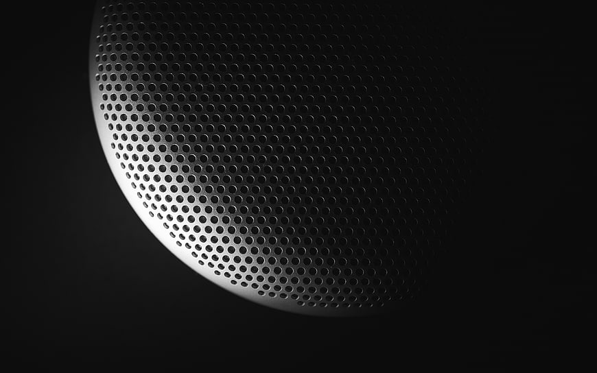 Close-up of perforated metal speaker grille texture