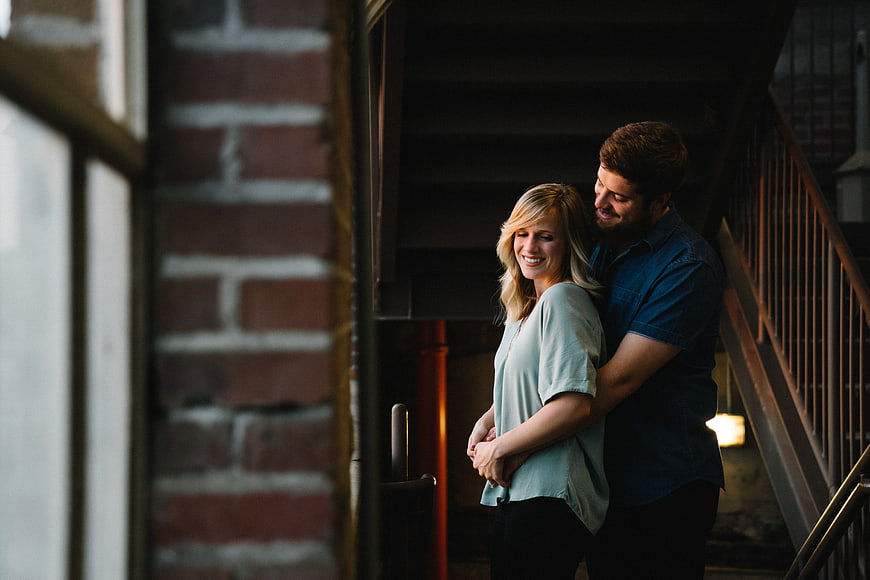 Happy couple embracing on rustic staircase