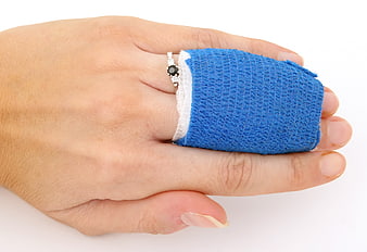 Close-up of hand with blue bandage on finger