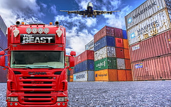 Red Scania Truck, Cargo Containers, and Airplane in Logistics Yard
