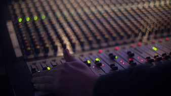 Sound Engineer Hand Adjusting Audio Mixing Console Faders