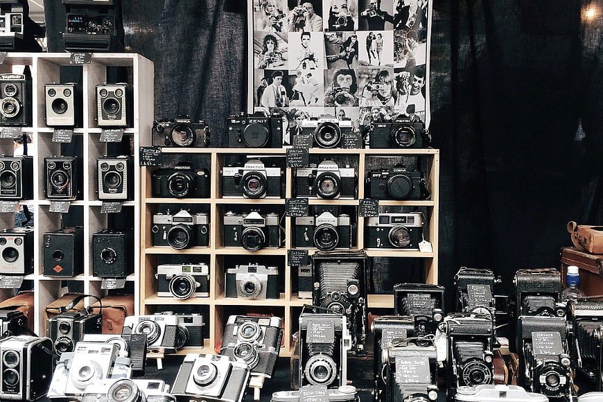 Vintage Camera Collection on Wooden Shelves