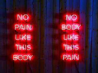 Red Neon Signs Reading No Pain Like This Body on Wood Wall