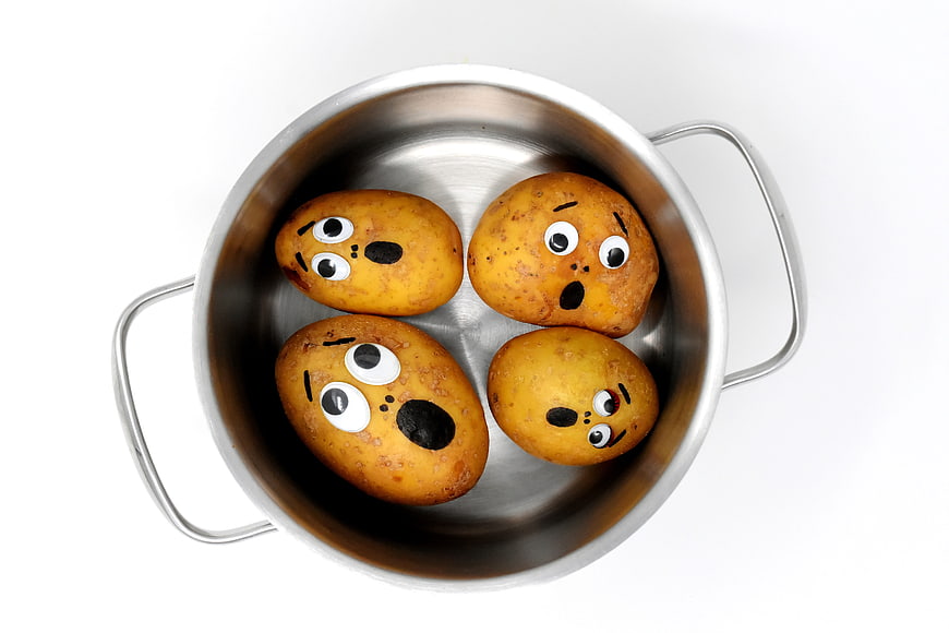 Funny Potatoes With Faces In Metal Pot
