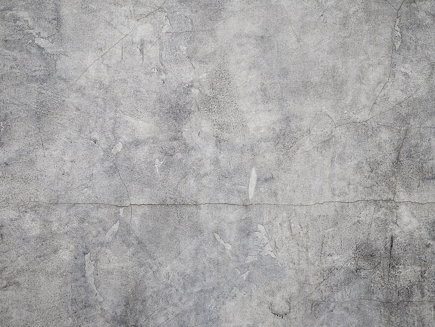 Textured gray concrete wall background with cracks