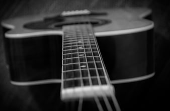 Black and White Acoustic Guitar Close-Up with Shallow Depth of Field