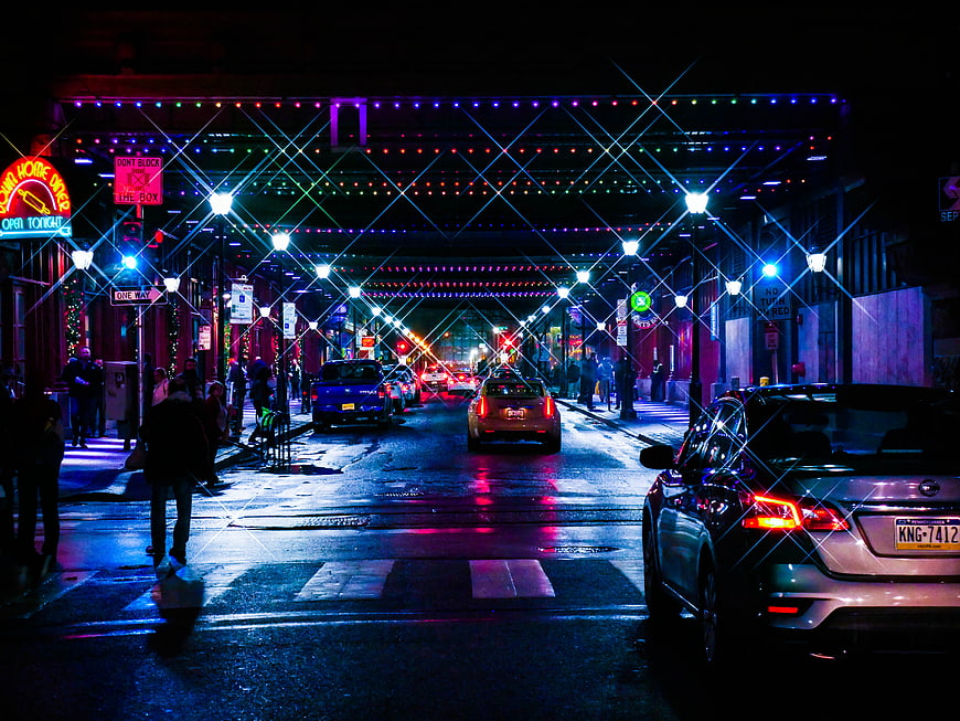 Vibrant Night Street Scene with Neon Lights and Traffic